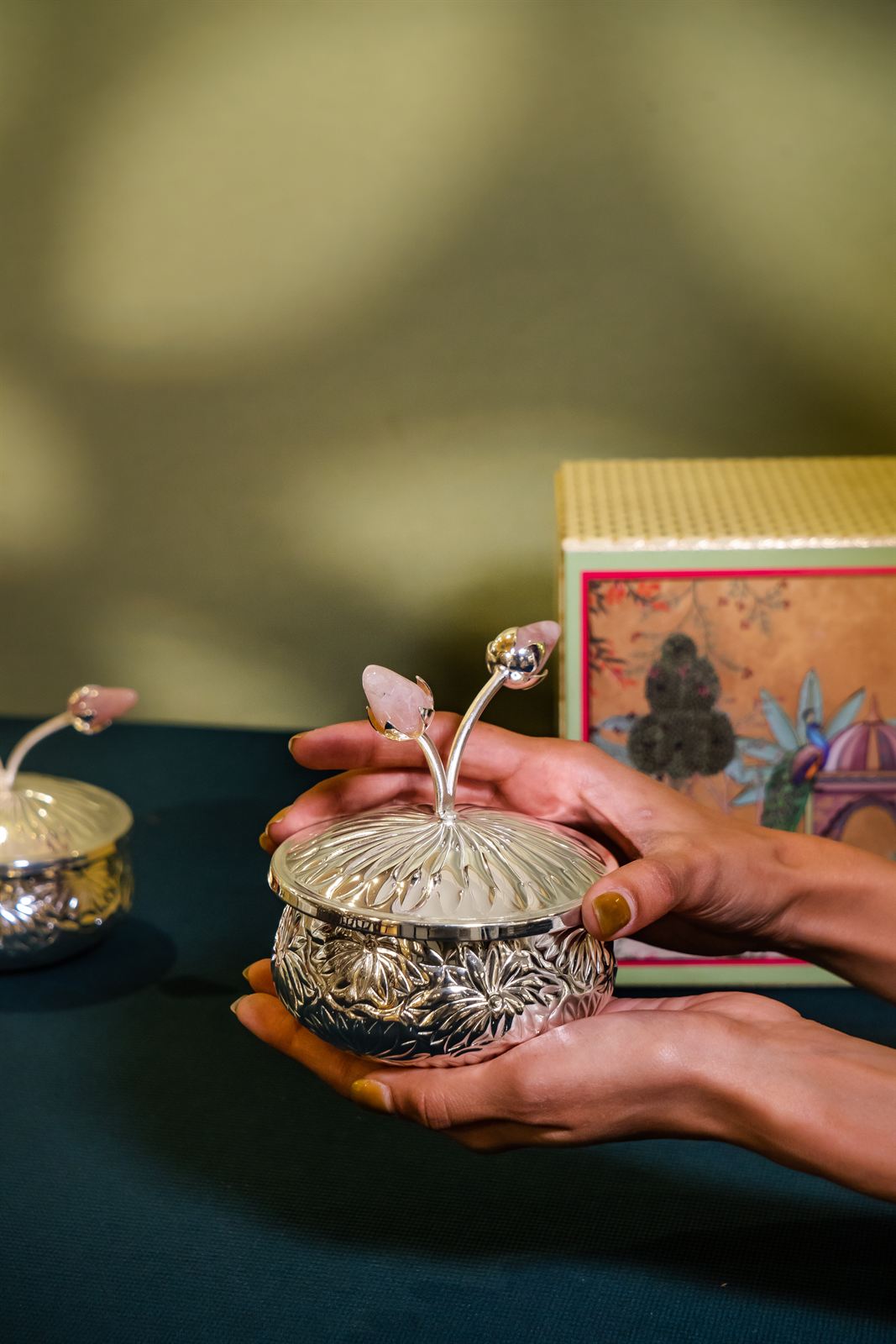 Hands cradling a silver keepsake bowl